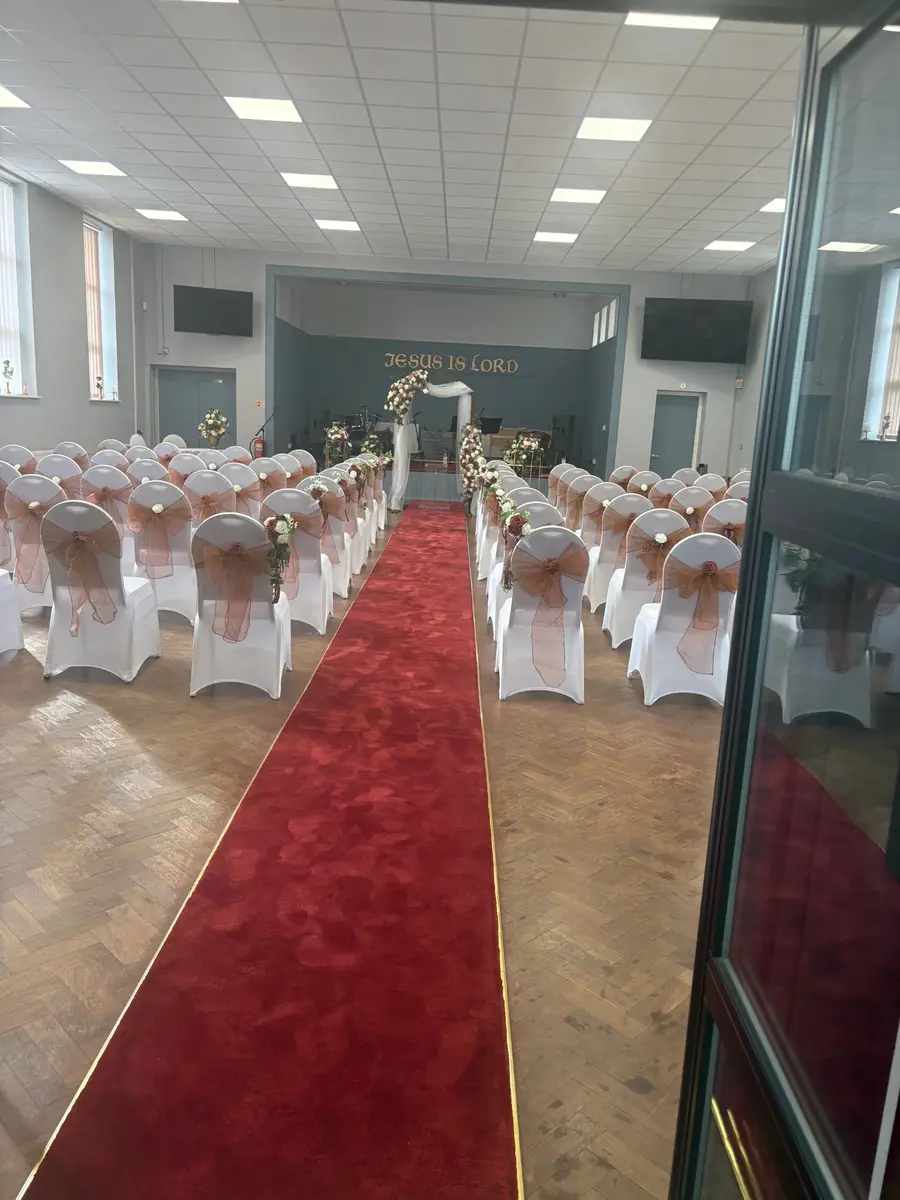 Main church hall at Full Gospel Tabernacle set out with a red aisle carpet Birmingham